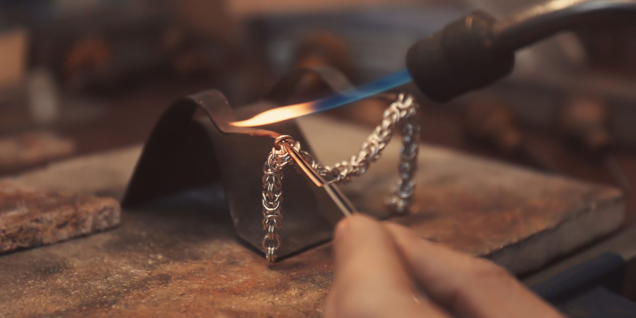 Jeweler working with blow torch, closeup